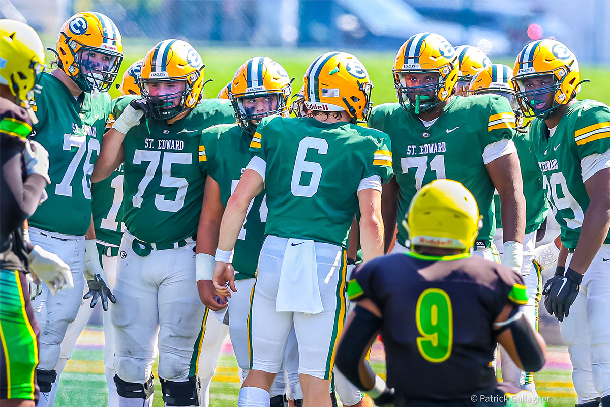 the st. edward football offensive line leaving a huddle during a game