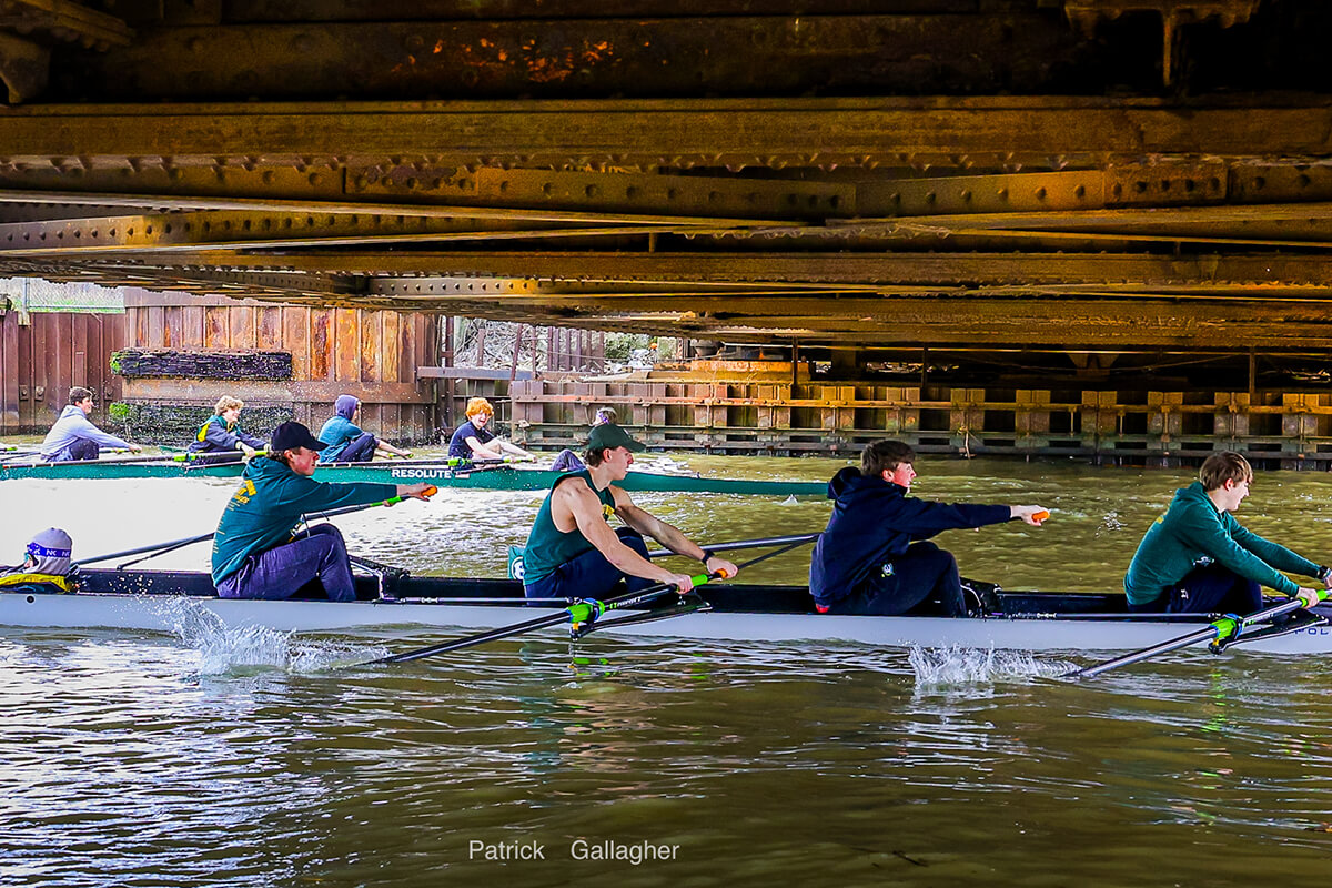 st. edward high school rowers row underneath a bridge in cleveland